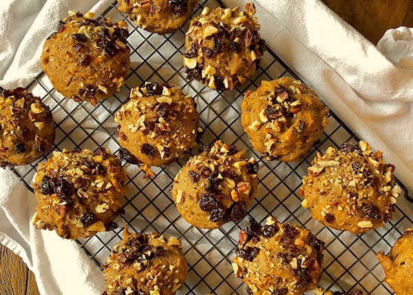 Several delicious looking muffins cooling on a rack