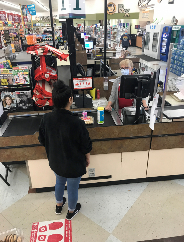 Woman in a face mask at a cash register